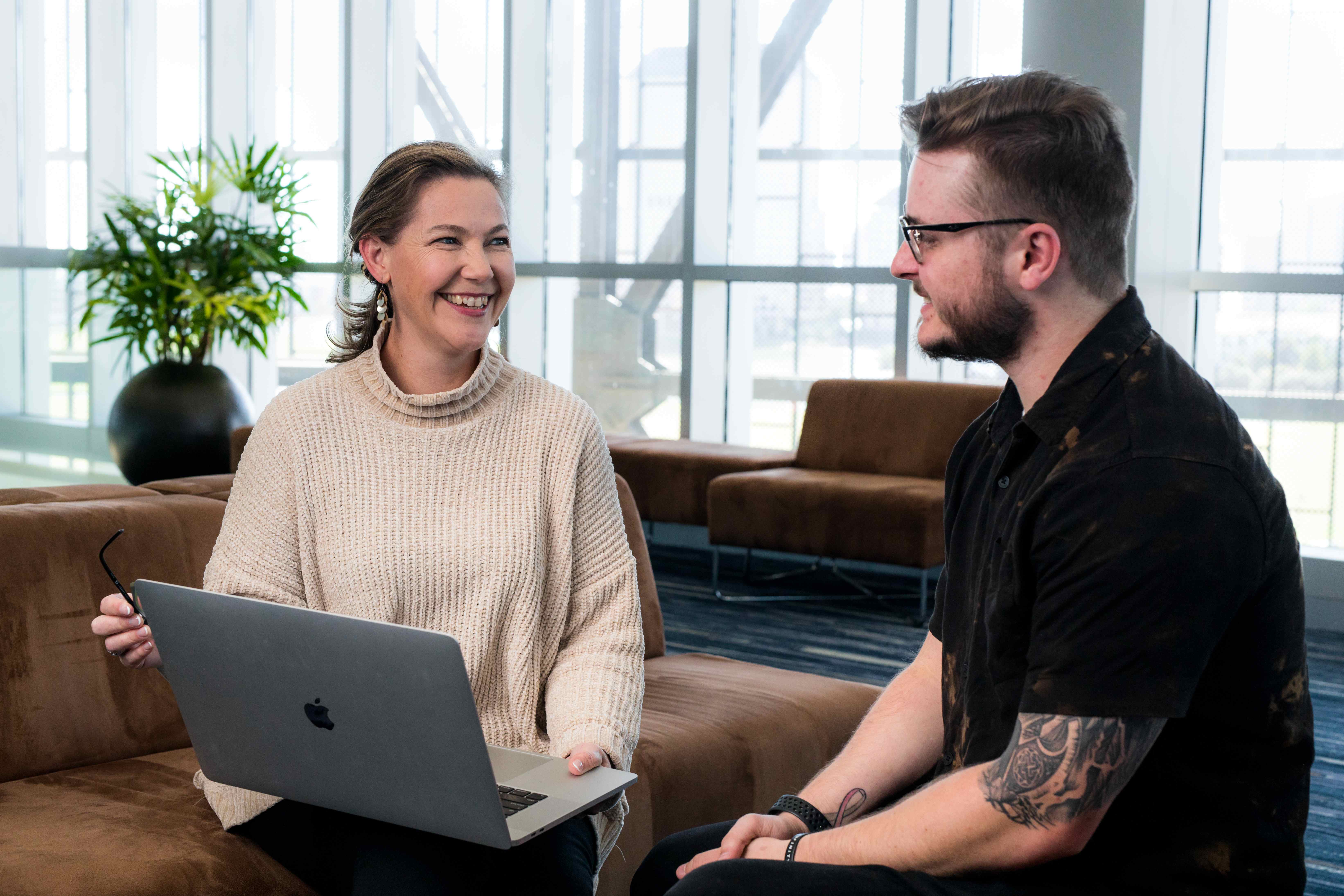 Professional consultation meeting between two people in modern office setting